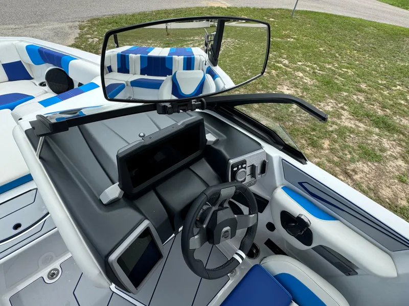 Slide: The Image of 2024 Malibu Wakesetter 21 LX boat interior with steering wheel and dashboard. - 23