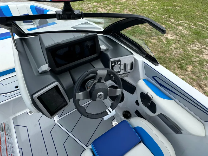 Slide: The Image of 2024 Malibu Wakesetter 21 LX boat cockpit with modern steering wheel and control panel. - 24