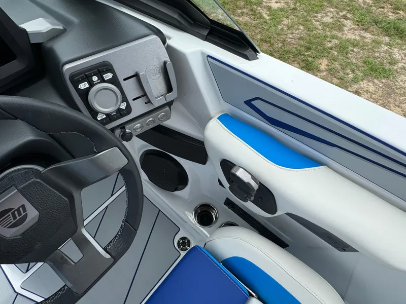 Slide: The Image of 2024 Malibu Wakesetter 21 LX boat interior, steering wheel, and control panel. - 25