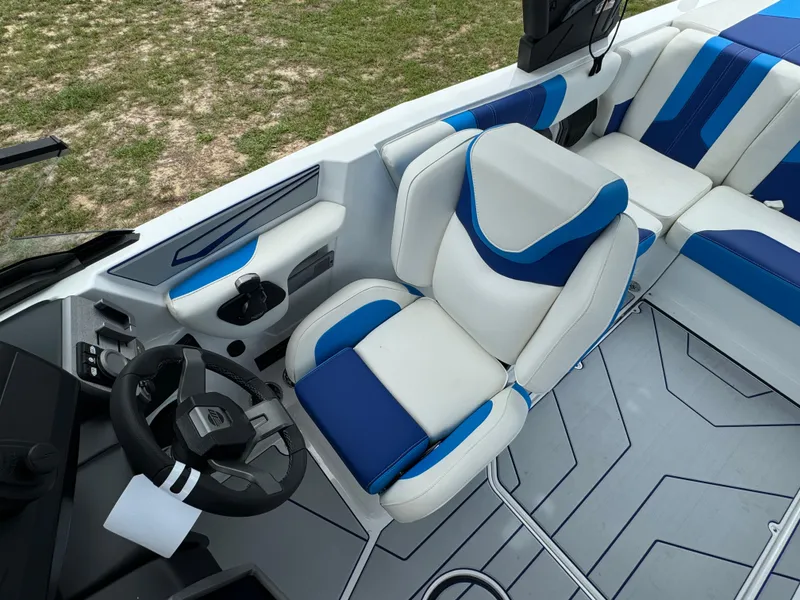 Slide: The Image of 2024 Malibu Wakesetter 21 LX boat interior with blue and white seating. - 26