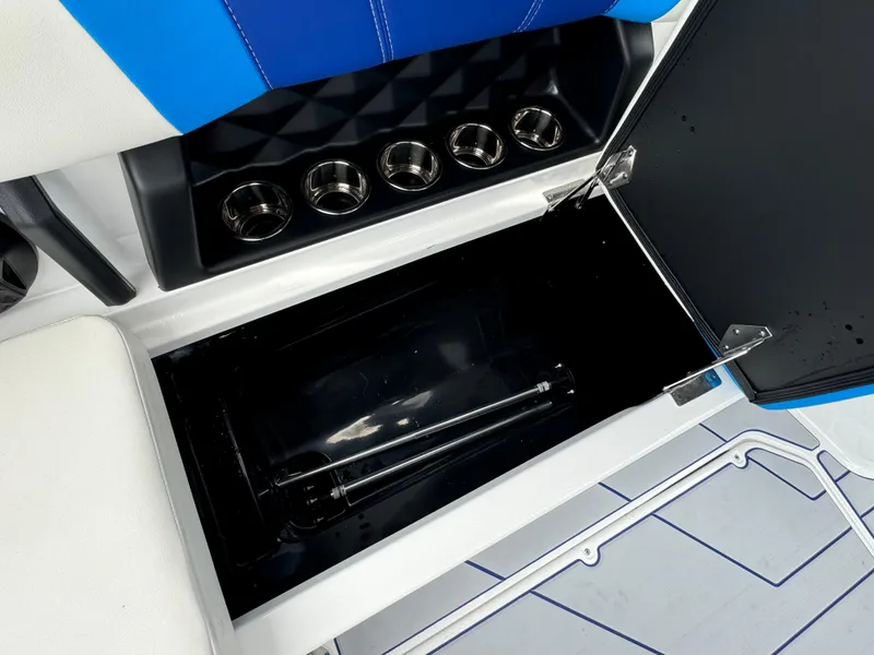 Slide: The Image of 2024 Malibu Wakesetter 21 LX storage compartment and cup holders. - 34