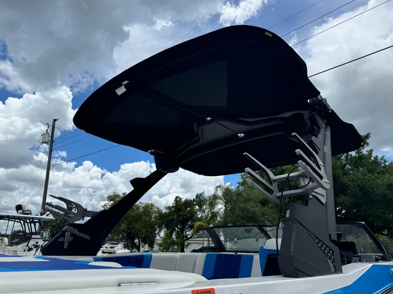 Slide: The Image of 2024 Malibu Wakesetter 21 LX boat with wakeboard tower against cloudy sky. - 35