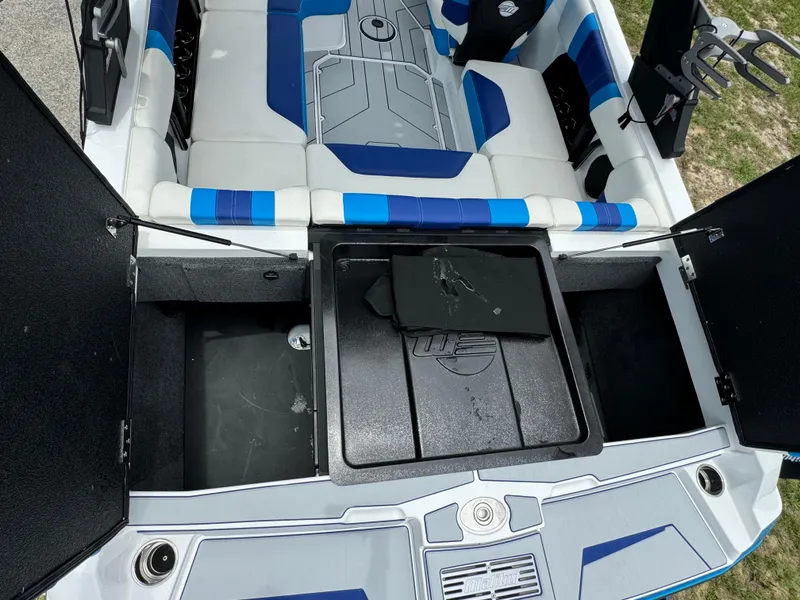 Slide: The Image of 2024 Malibu Wakesetter 21 LX interior with open storage compartments. - 39