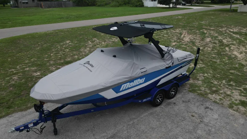 Slide: The Image of 2024 Malibu Wakesetter 21 LX boat on trailer with cover. - 45