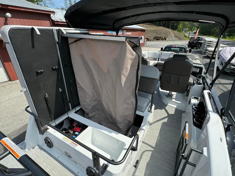 Slide: The Image of 2024 Princecraft VOGUE 23RL pontoon boat interior with storage compartment open. - 24