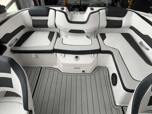 Slide: The Image of 2024 Yamaha Boats 195S interior seating area with white and black upholstery. - 10