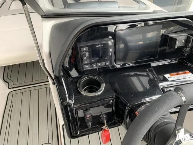 Slide: The Image of 2024 Yamaha Boats 195S dashboard with control panel and steering wheel. - 11