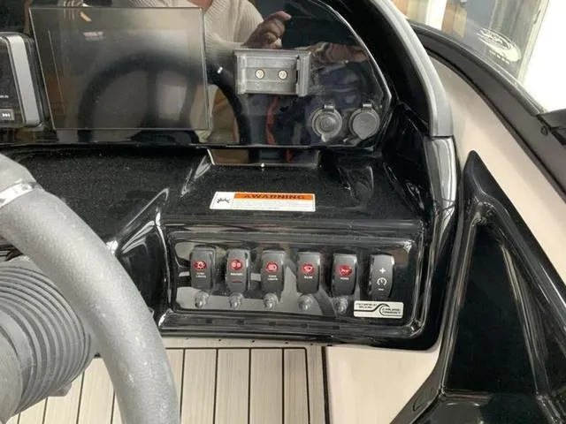 Slide: The Image of Control panel of a 2024 Yamaha Boats 195S with switches and display screen. - 12