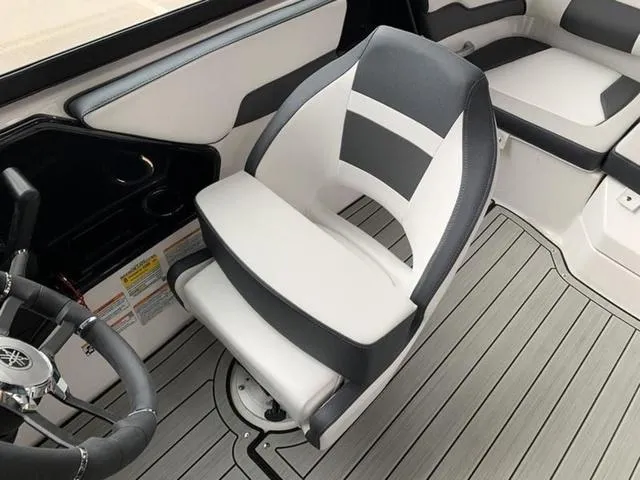 Slide: The Image of Yamaha Boats 2024 195S interior, featuring a sleek captain's chair and modern dashboard. - 14