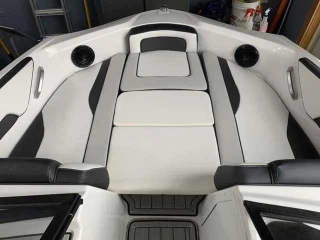 Slide: The Image of 2024 Yamaha Boats 195S interior seating area with white and black upholstery. - 16