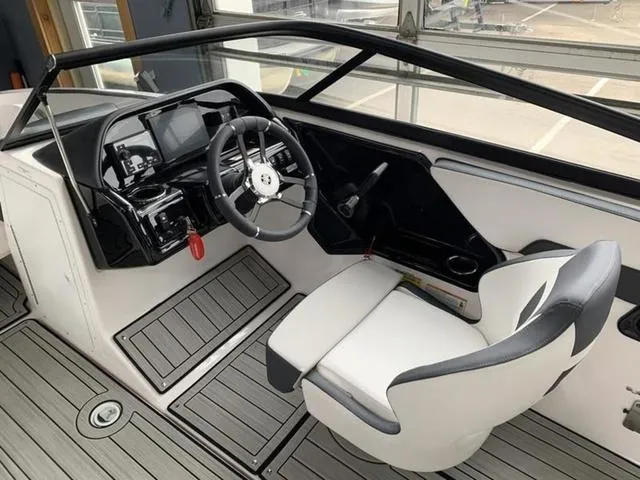 Slide: The Image of 2024 Yamaha Boats 195S cockpit with steering wheel and captain's chair. - 17