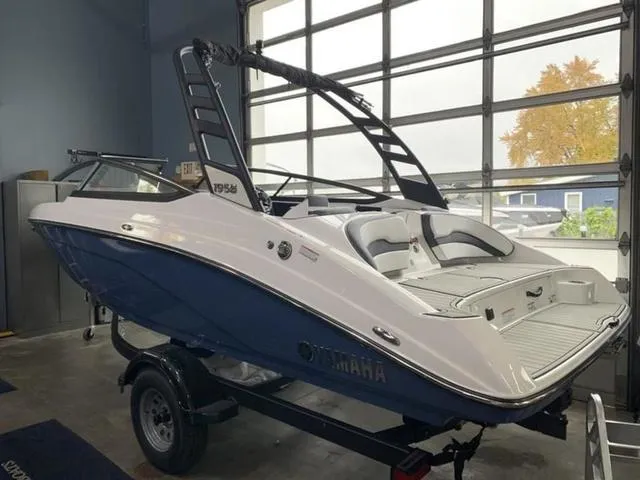 Slide: The Image of 2024 Yamaha Boats 195S in a showroom, blue and white exterior. - 3