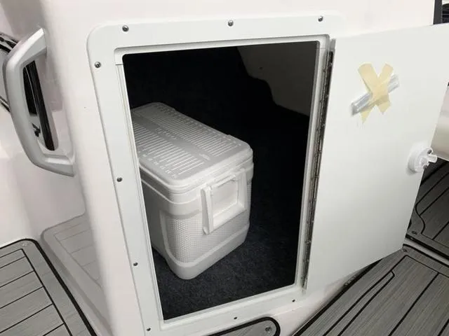 Slide: The Image of Storage compartment with cooler on 2024 Yamaha Boats 195S. - 4