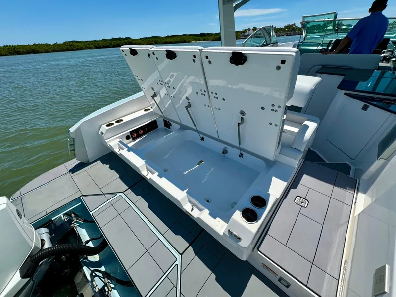 Slide: The Image of 2021 Aviara AV32 OB boat with open storage compartment on a sunny day. - 20