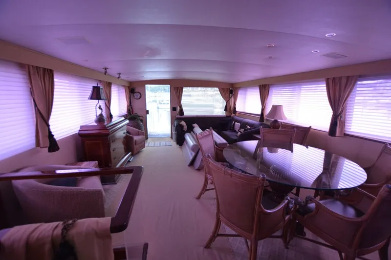 Slide: The Image of Luxurious interior of 1989 Hatteras Cockpit Motoryacht with elegant furnishings and large windows. - 10