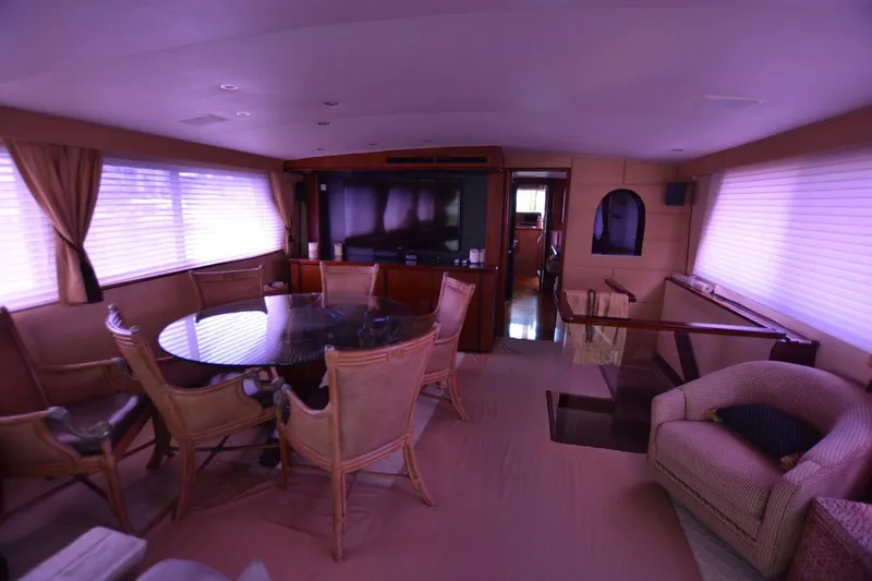 Slide: The Image of Interior of 1989 Hatteras Cockpit Motoryacht with dining area and lounge seating. - 11