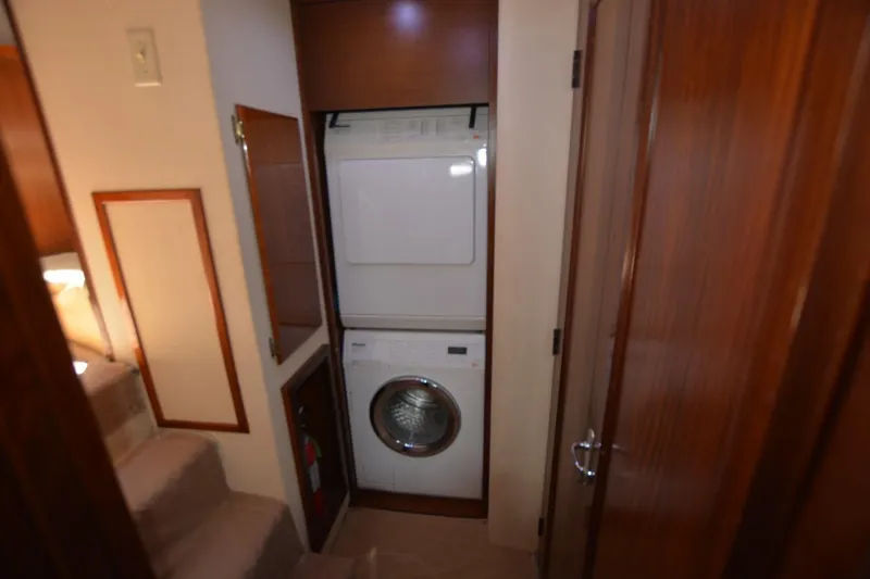 Slide: The Image of Laundry area in 1989 Hatteras Cockpit Motoryacht with stacked washer and dryer. - 19
