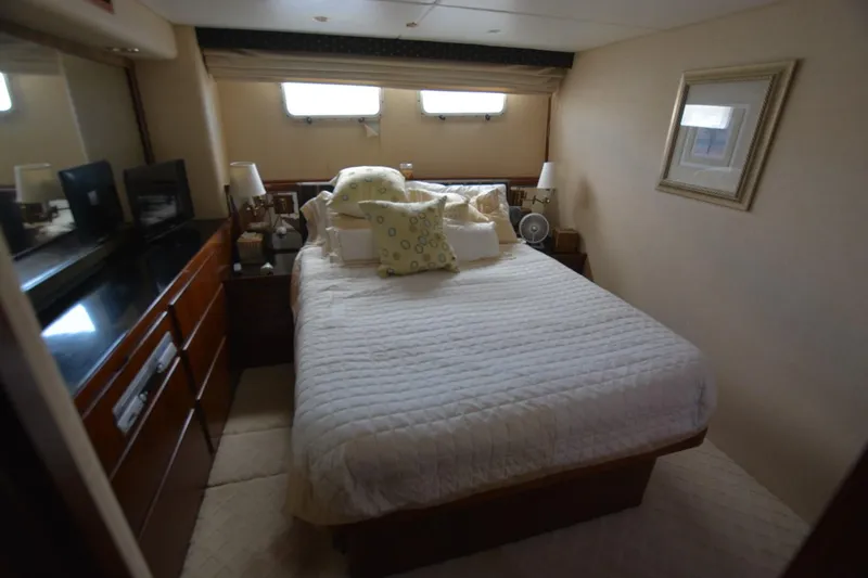 Slide: The Image of 1989 Hatteras Cockpit Motoryacht bedroom with cozy bed and elegant decor. - 20