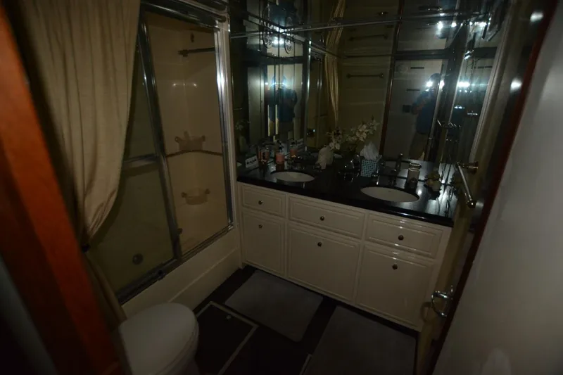 Slide: The Image of Luxurious bathroom in 1989 Hatteras Cockpit Motoryacht with dual sinks and shower. - 24