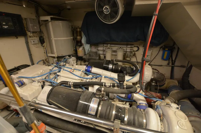 Slide: The Image of Engine room of 1989 Hatteras Cockpit Motoryacht with visible machinery and components. - 28