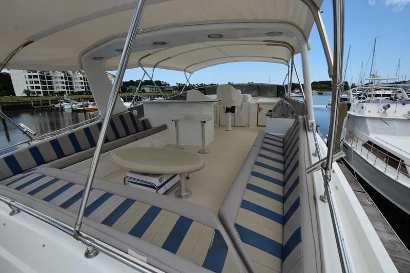 Slide: The Image of 1989 Hatteras Cockpit Motoryacht with spacious seating and elegant design at marina. - 3