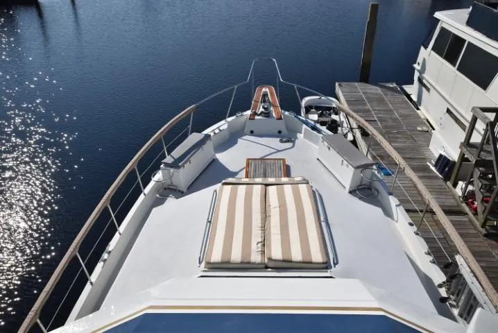 Slide: The Image of 1989 Hatteras Cockpit Motoryacht with sun deck, docked at marina. - 30