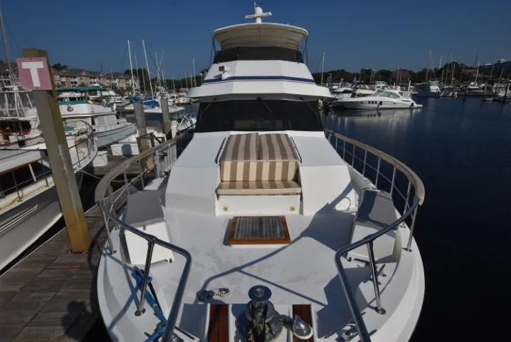 Slide: The Image of 1989 Hatteras Cockpit Motoryacht docked in marina, front view. - 31