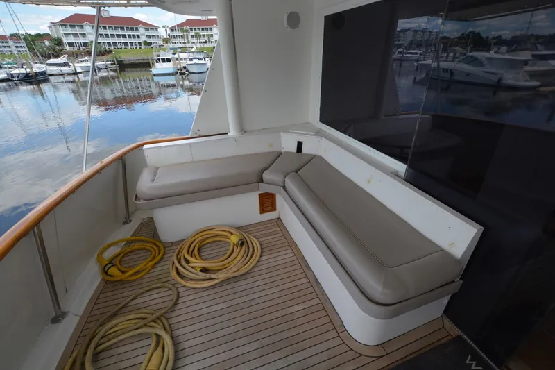 Slide: The Image of 1989 Hatteras Cockpit Motoryacht with spacious seating area and marina view. - 6