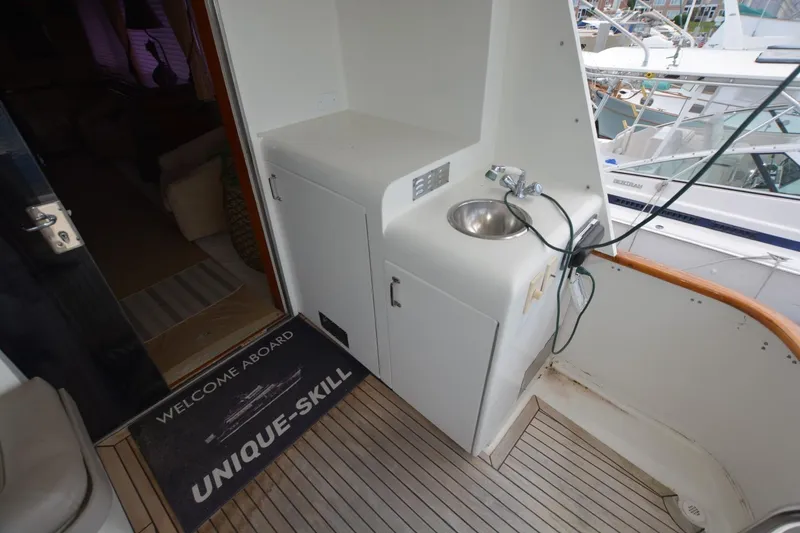 Slide: The Image of 1989 Hatteras Cockpit Motoryacht deck with sink and welcome mat. - 7