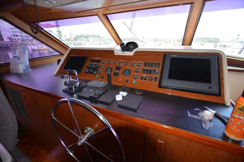 Slide: The Image of 1989 Hatteras Cockpit Motoryacht helm with navigation instruments and steering wheel. - 8