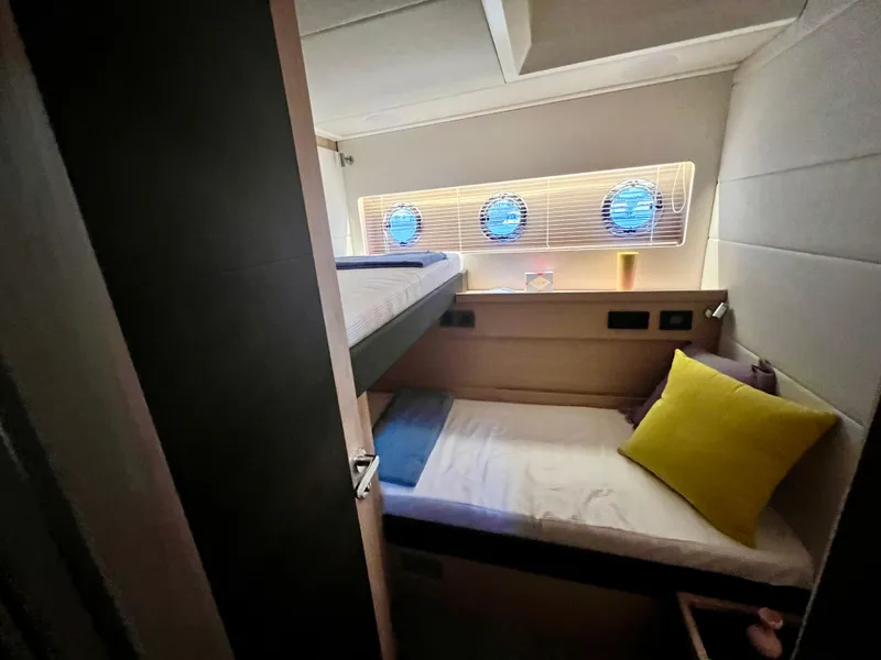 Slide: The Image of Cozy cabin with bunk beds on 2025 Beneteau Swift Trawler 54 yacht. - 20