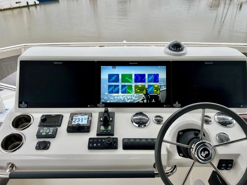 Slide: The Image of Helm station of 2025 Beneteau Swift Trawler 54 with advanced navigation systems. - 22