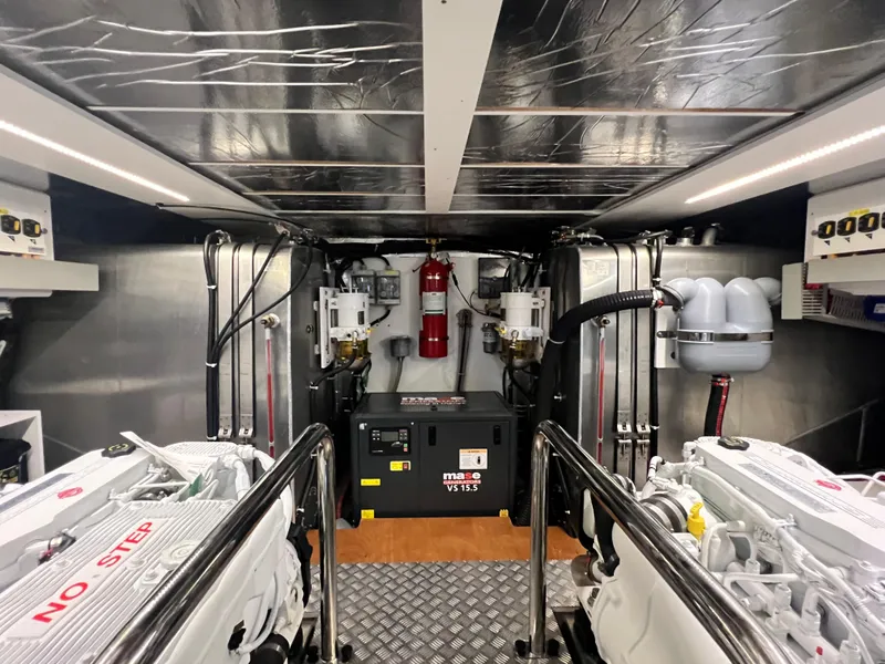 Slide: The Image of Engine room of a 2025 Beneteau Swift Trawler 54 with dual engines and safety equipment. - 30