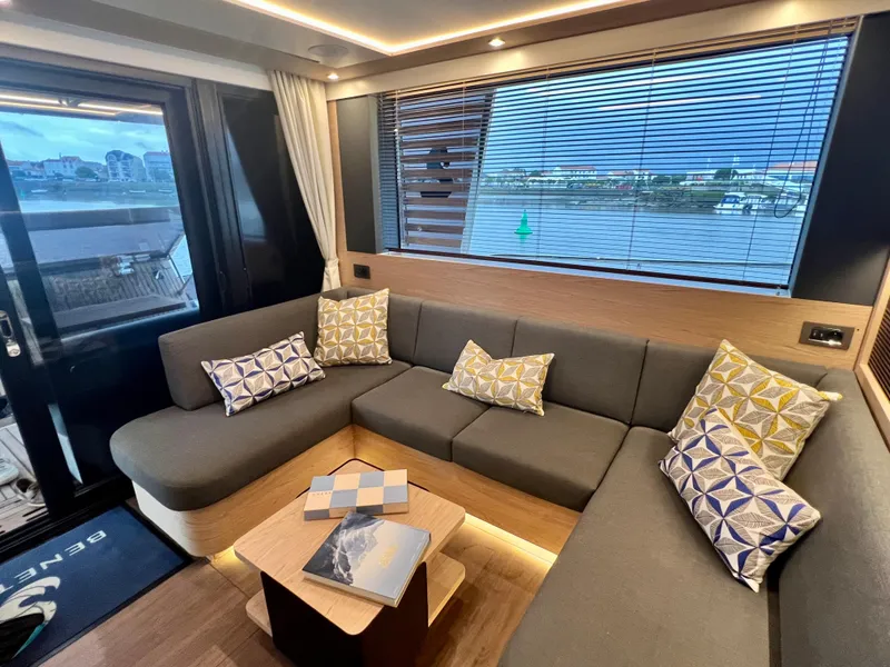 Slide: The Image of Modern interior of 2025 Beneteau Swift Trawler 54 with cozy seating and decorative pillows. - 5