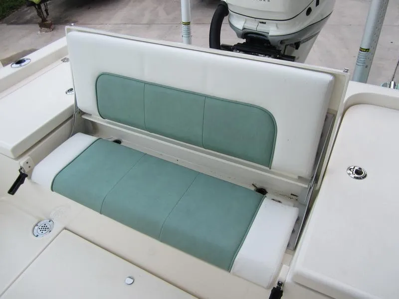 Slide: The Image of 2021 ShearWater 250 Carolina Bay boat with green and white cushioned seating. - 18