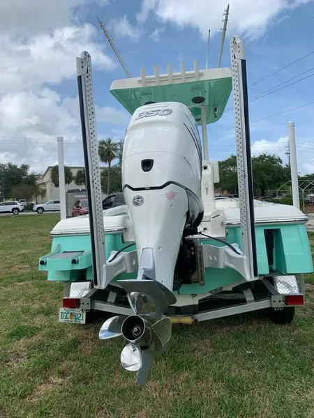 Slide: The Image of 2021 ShearWater 250 Carolina Bay boat with outboard motor on trailer. - 2