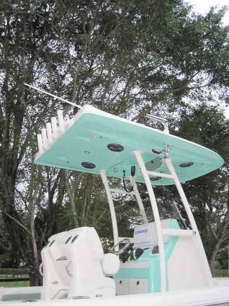 Slide: The Image of 2021 ShearWater 250 Carolina Bay boat with T-top and rod holders. - 3