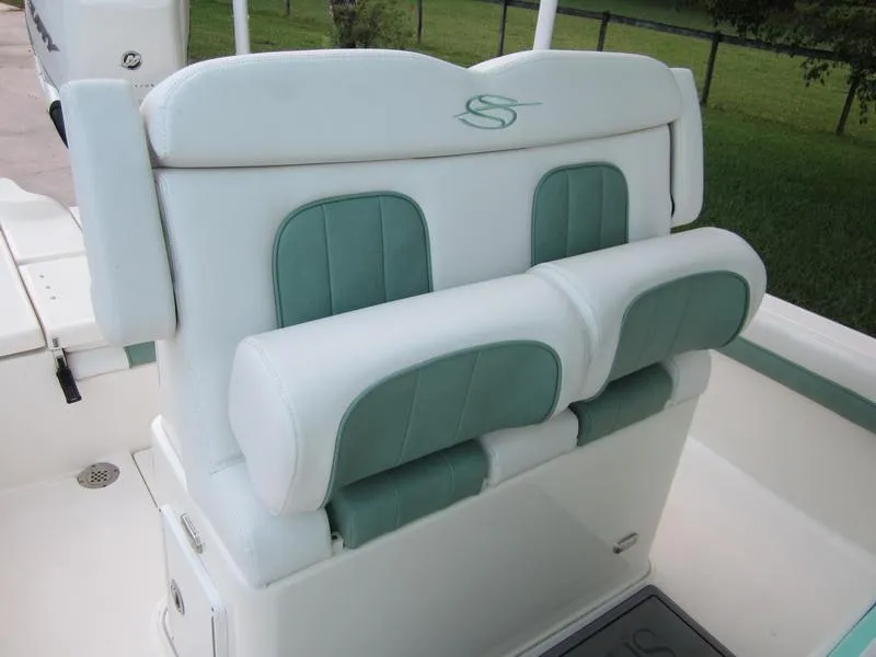 Slide: The Image of 2021 ShearWater 250 Carolina Bay boat seating with white and green cushions. - 4