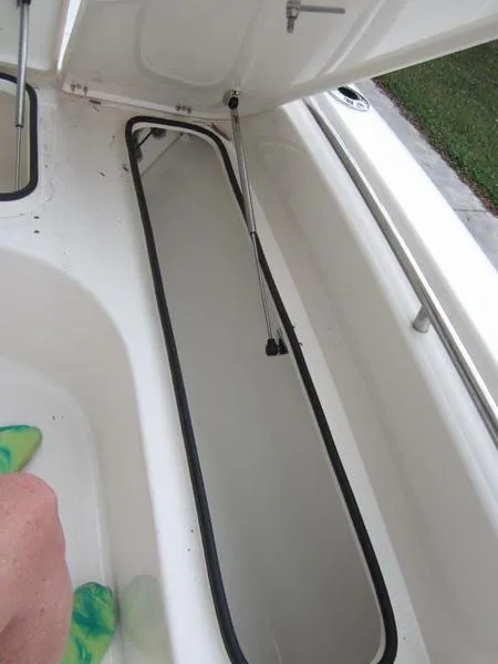 Slide: The Image of 2021 ShearWater 250 Carolina Bay storage compartment with open hatch. - 6