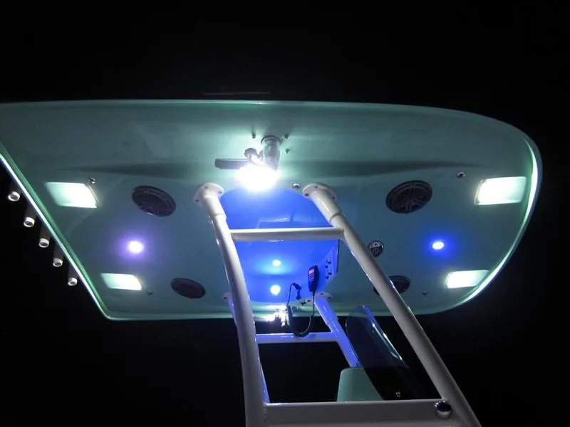 Slide: The Image of 2021 ShearWater 250 Carolina Bay boat with illuminated T-top at night. - 7