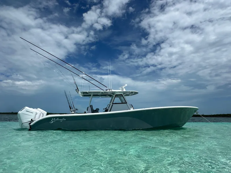 The Image of 2024 Yellowfin 39 boat in clear turquoise water under a partly cloudy sky. - 0