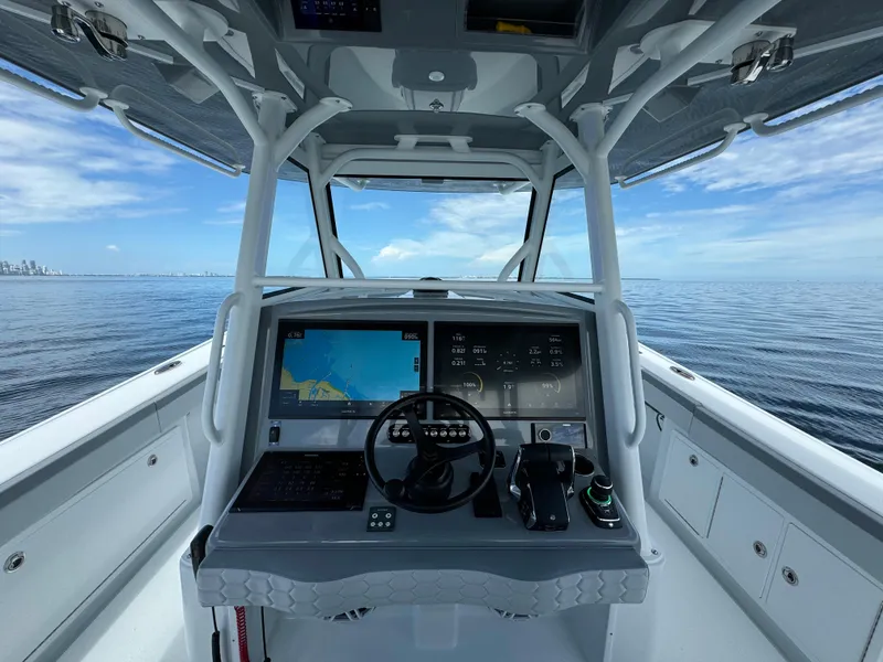 Slide: The Image of 2024 Yellowfin 39 boat helm with navigation screens on open water. - 12