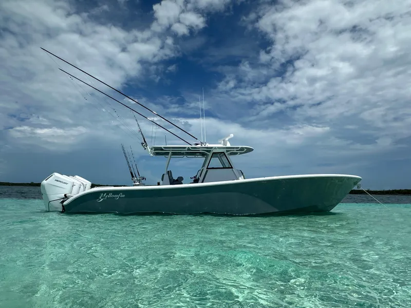 Slide: The Image of 2024 Yellowfin 39 boat in clear turquoise water under a partly cloudy sky. - 2