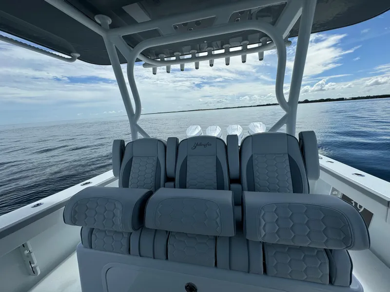 Slide: The Image of 2024 Yellowfin 39 boat interior with luxurious seating on calm waters. - 20