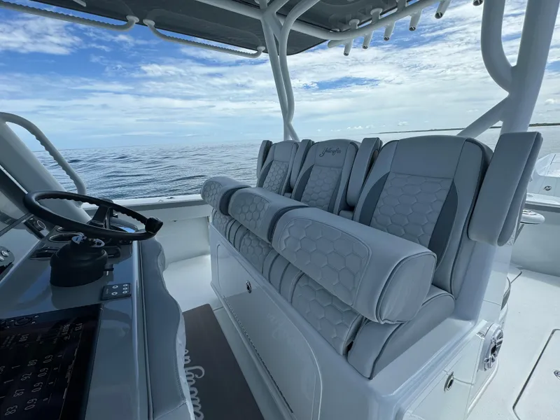 Slide: The Image of 2024 Yellowfin 39 boat interior with luxurious seating and ocean view. - 22