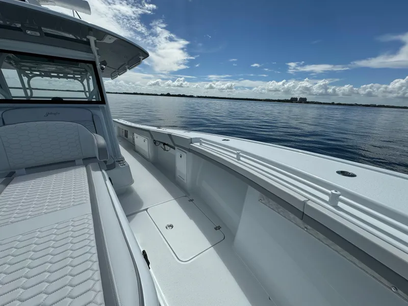 Slide: The Image of 2024 Yellowfin 39 boat on calm water under a clear blue sky. - 27