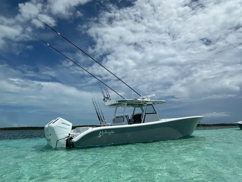 Slide: The Image of 2024 Yellowfin 39 boat in clear turquoise water under a partly cloudy sky. - 3