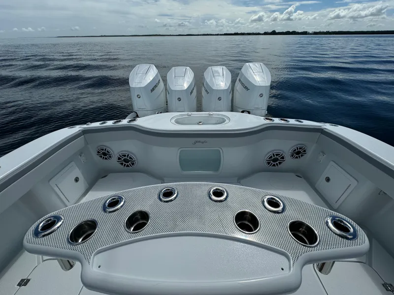Slide: The Image of 2024 Yellowfin 39 boat with quad outboard engines on calm water. - 32