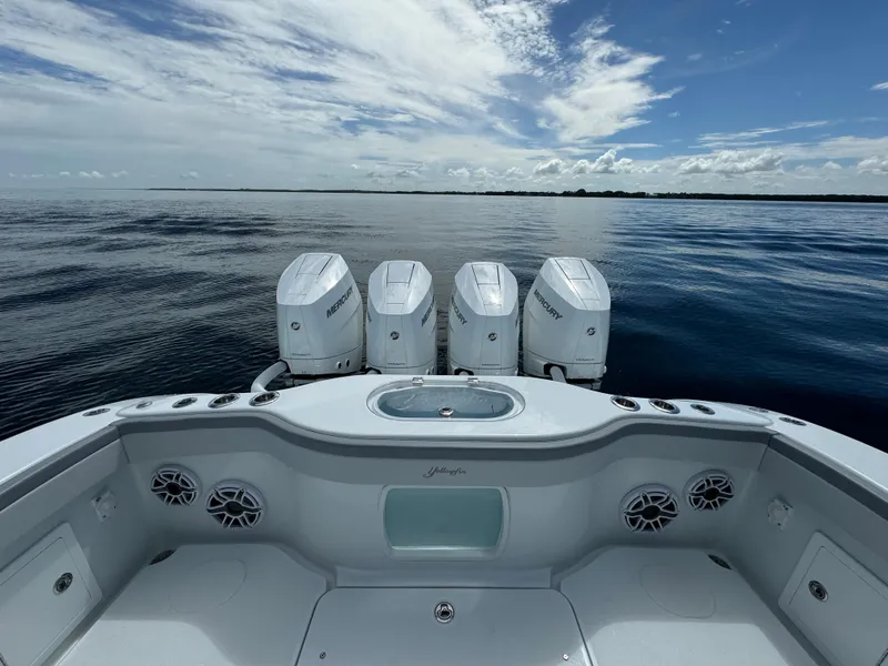 Slide: The Image of 2024 Yellowfin 39 boat with four outboard engines on calm water. - 33