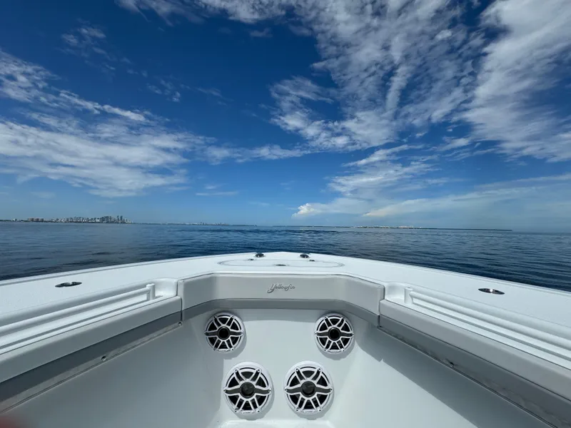 Slide: The Image of 2024 Yellowfin 39 boat on calm ocean with blue sky and clouds. - 34